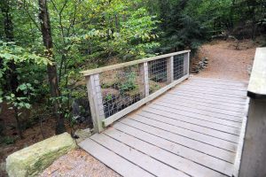 As part of the Trail Management and Maintenance Plan, a short bridge was installed over this perennial stream. The bridge's railing system and stone cribbing work together to provide safe passage for the trail user while protecting the stream ecosystem.